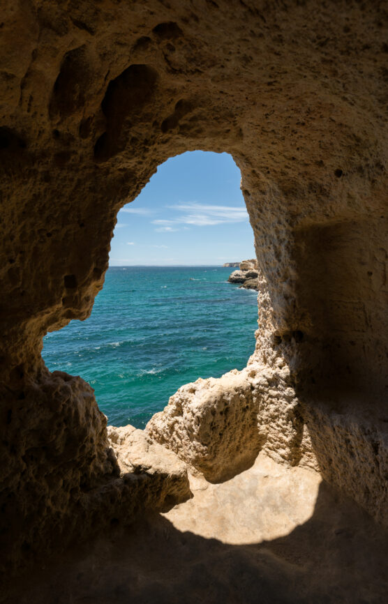 Wooden boardwalk along limestone cliffs at Algar Seco, Carvoeiro, with Atlantic Ocean views