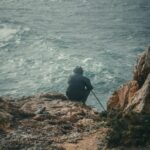 Dramatic cliff coastline along the Fishermens Trail in the Algarve with wildflowers