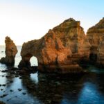 Golden limestone rock formations at Ponta da Piedade with turquoise water and dramatic sea arches near Lagos